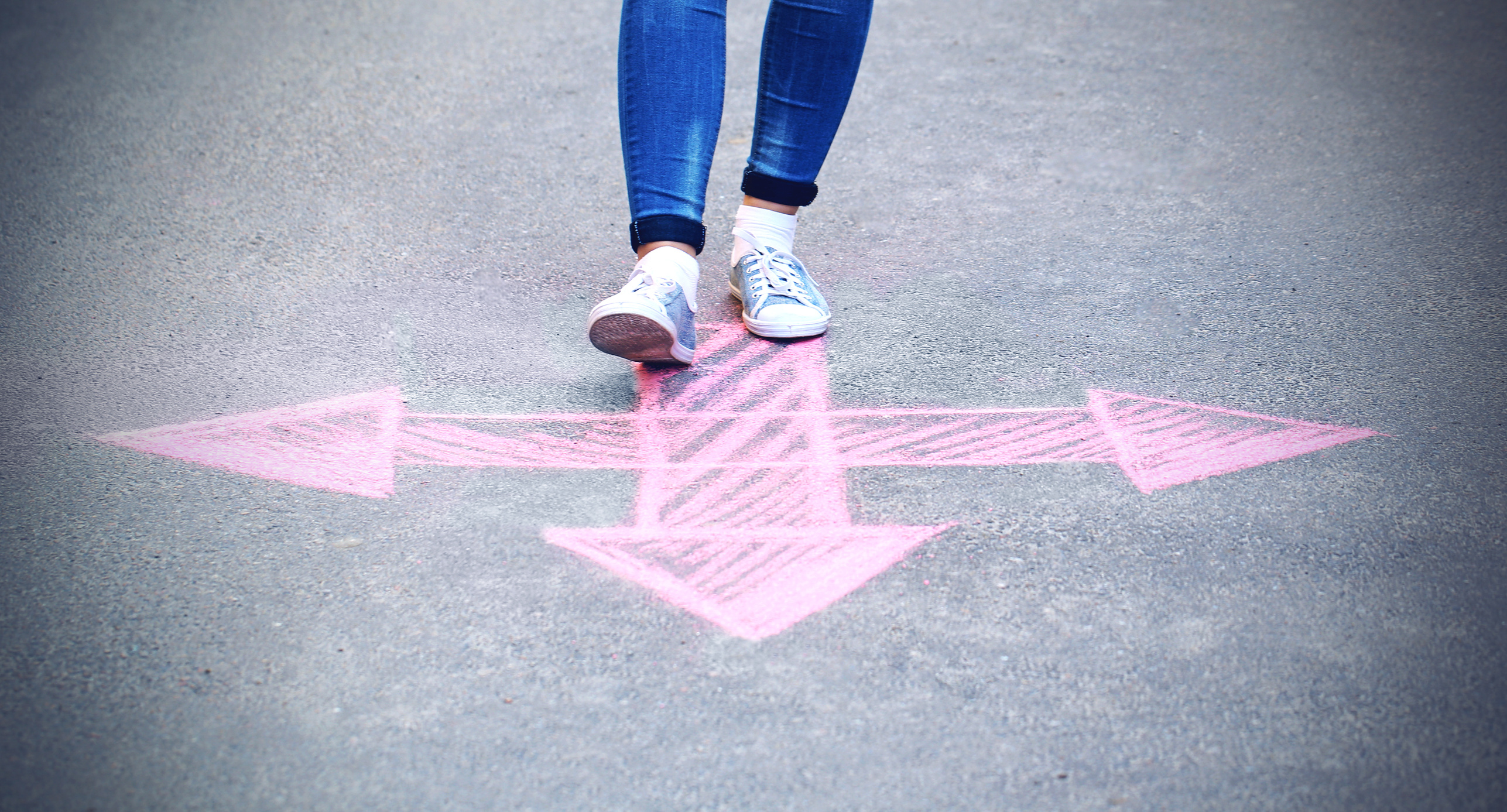 Feet and Drawing Arrows on Pavement Background